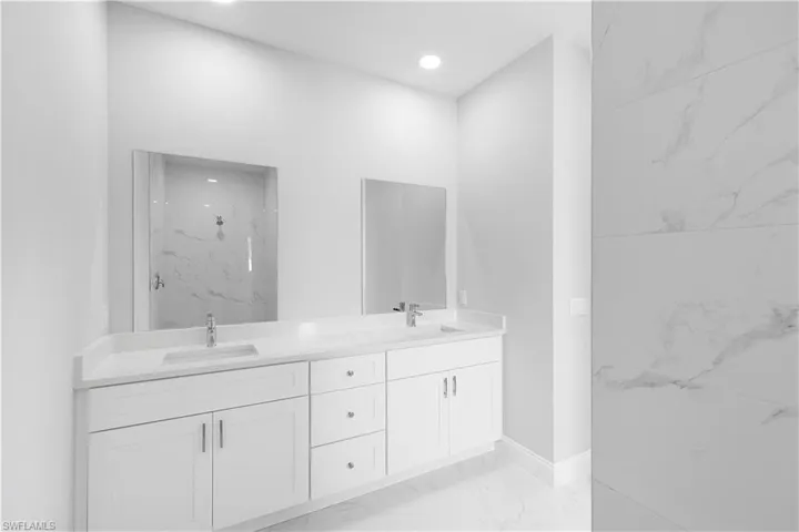 Bathroom featuring double sink vanity and tile patterned floors