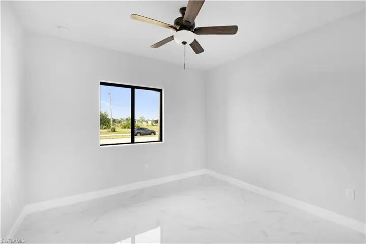 Spare room with ceiling fan