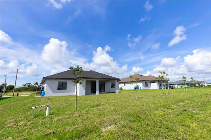 Rear view of property featuring a lawn
