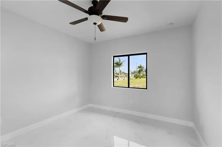 Empty room featuring ceiling fan