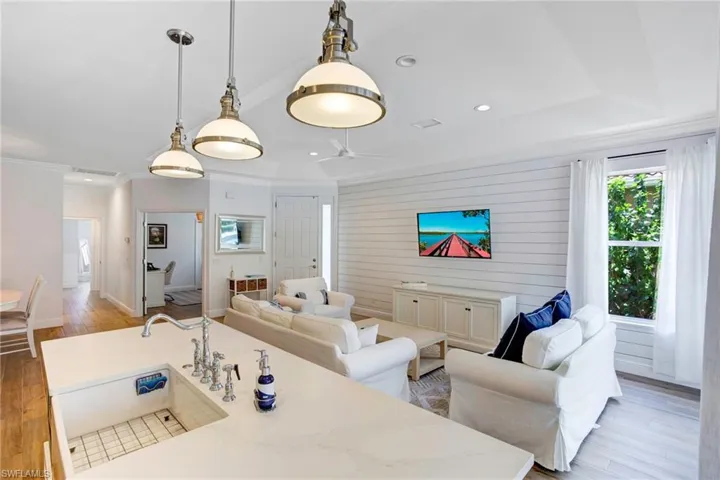 Living room with ceiling fan and light wood-type flooring