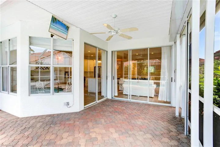 Unfurnished sunroom with plenty of natural light and ceiling fan