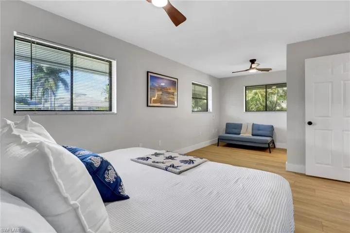 Bedroom 2 with light wood-style floors and a ceiling fan