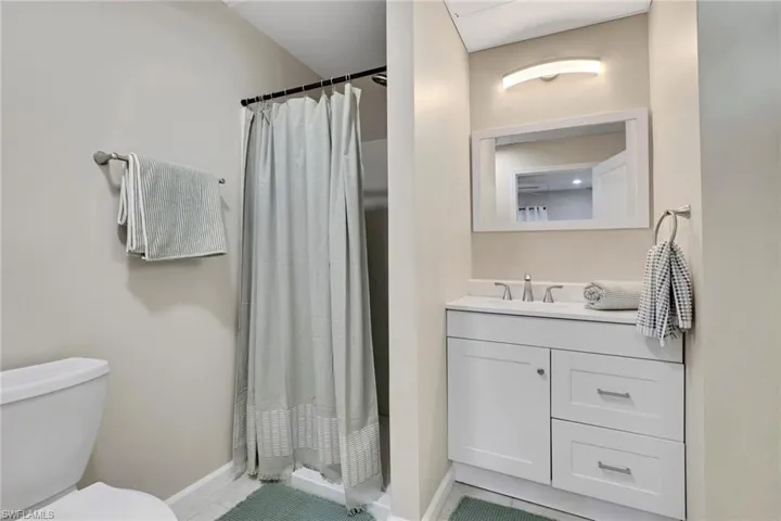 1/1 Efficiency-Bathroom with vanity and a shower stall