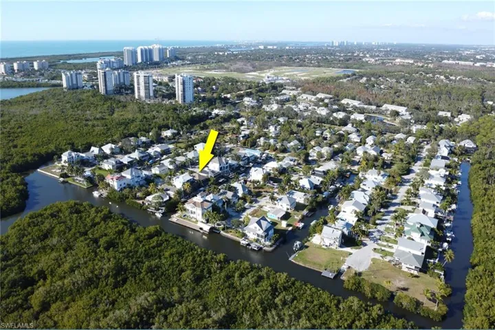 Aerial overview of property's location with a large body of water and nearby suburban area