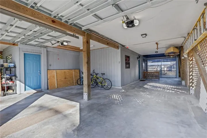Garage with wooden walls and a garage door opener