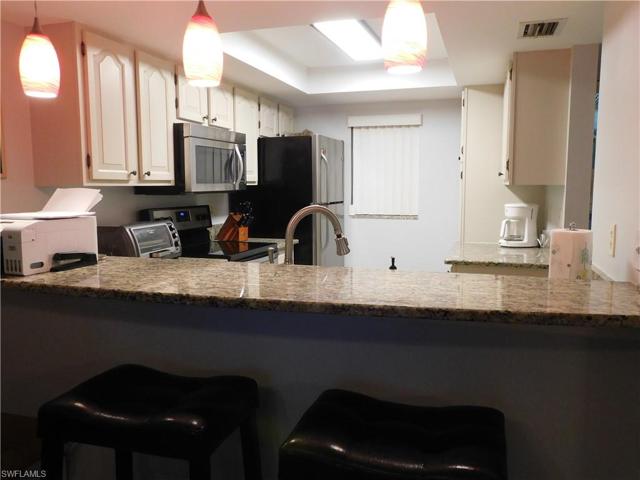 Kitchen has granite and stainless appliances