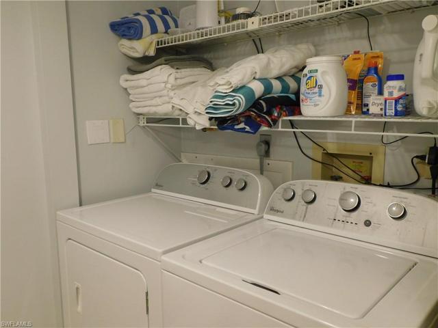 downstairs laundry in half bath with Whirlpool washer and dryer