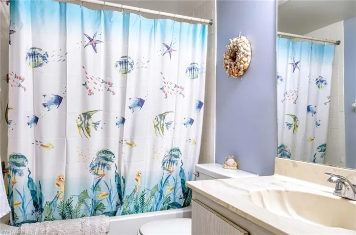 Full bathroom featuring vanity and shower / bath combo with shower curtain