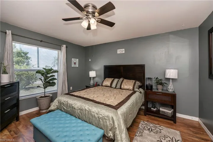 Bedroom with ceiling fan and wood-type flooring