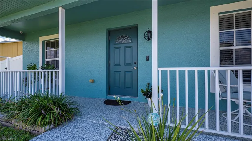 View of exterior entry with covered porch
