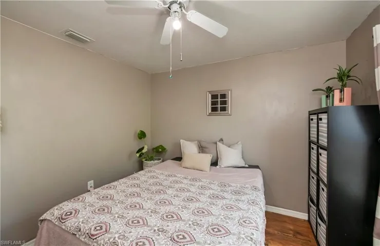 Bedroom featuring ceiling fan and hardwood / wood-style flooring