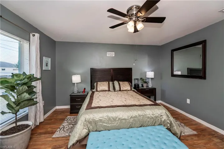 Bedroom with ceiling fan and dark hardwood / wood-style flooring