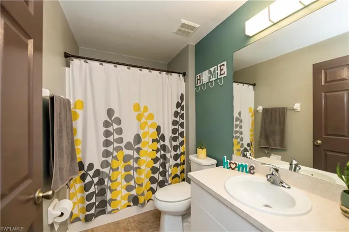 Bathroom with tile patterned floors, vanity, and toilet