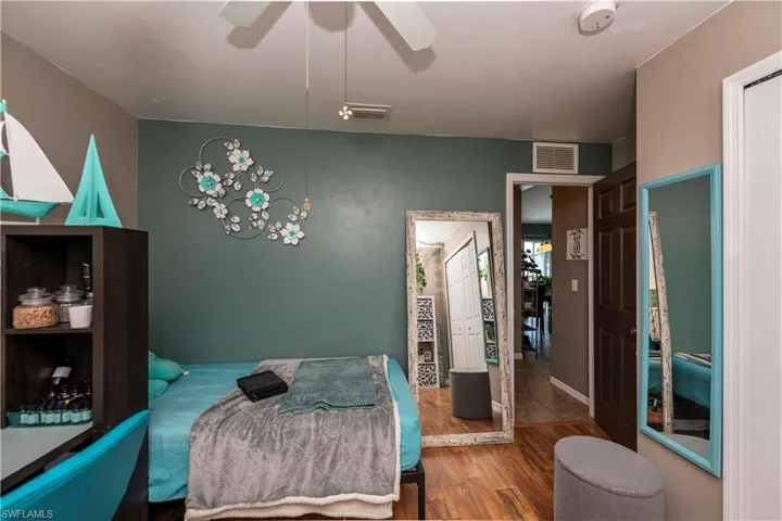 Tiled bedroom featuring ceiling fan