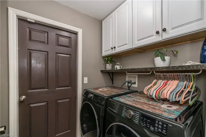 Laundry room with cabinets and independent washer and dryer