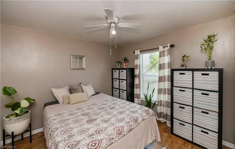 Bedroom with ceiling fan and hardwood / wood-style floors