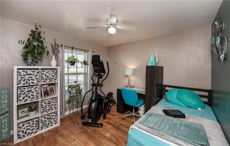 Bedroom featuring ceiling fan and hardwood / wood-style flooring