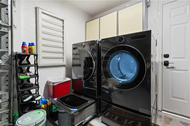 View of the Side Load Garage Laundry Corner with High End Stainless Washer w/Separate Delicate Hand Washer Drawer and High End Side Load Dryer.  NOTE A NEW/ NEVER USED Generator is in the Garage