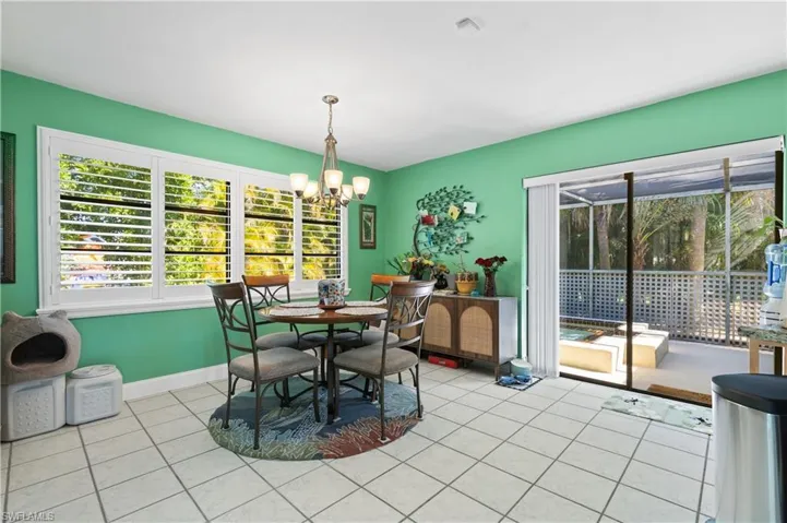 View of the attractive Dining Toom with Custom Installed Plantation Shuttered Windows to Back Yard . . . and Slider to the Separate Private Spa.