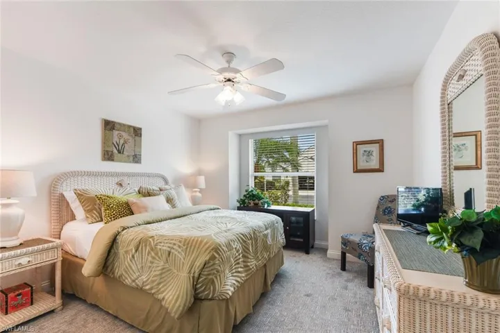 Bedroom with light colored carpet and ceiling fan