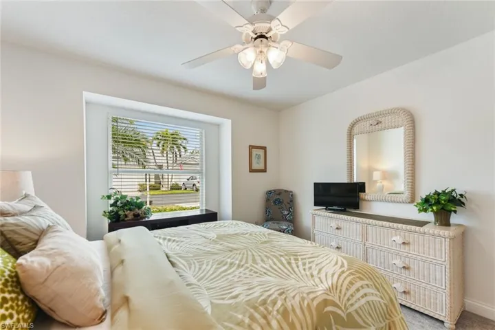 Bedroom with ceiling fan and carpet flooring