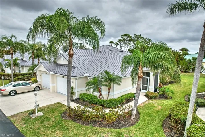 View of front of house with a garage and a front yard