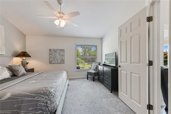 Bedroom featuring light carpet and ceiling fan