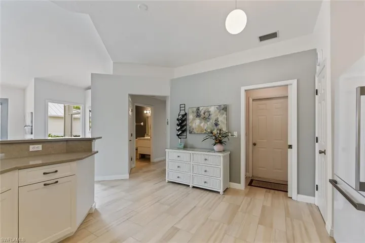 Kitchen with white cabinetry and hanging light fixtures