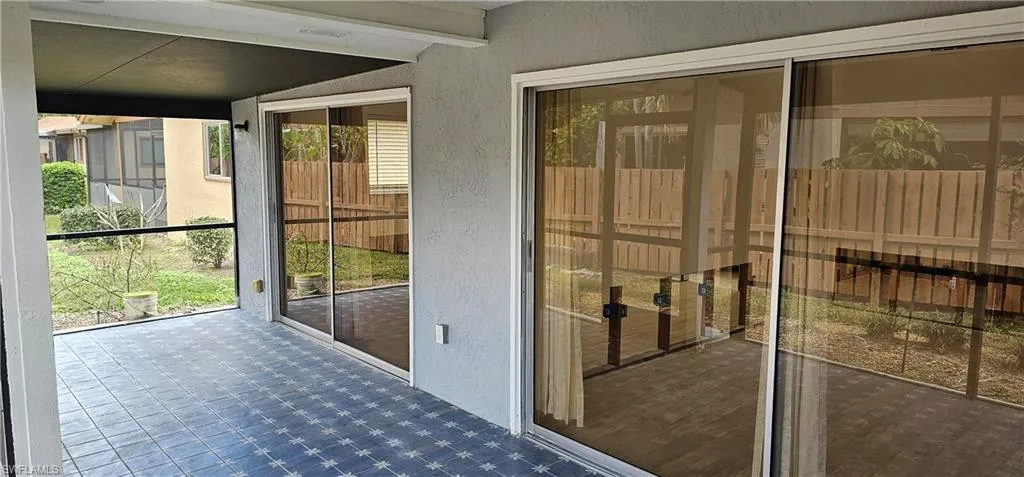 Doorway to outside featuring lofted ceiling with beams