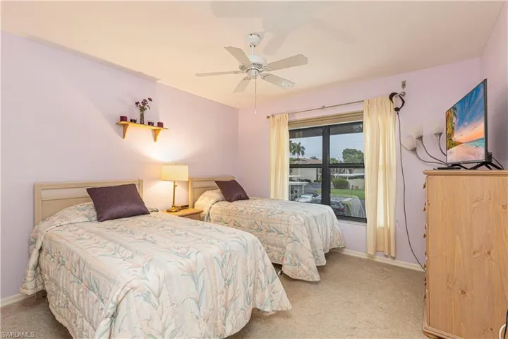 Carpeted bedroom with ceiling fan