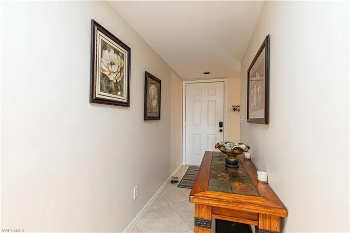 Hallway with light tile patterned floors