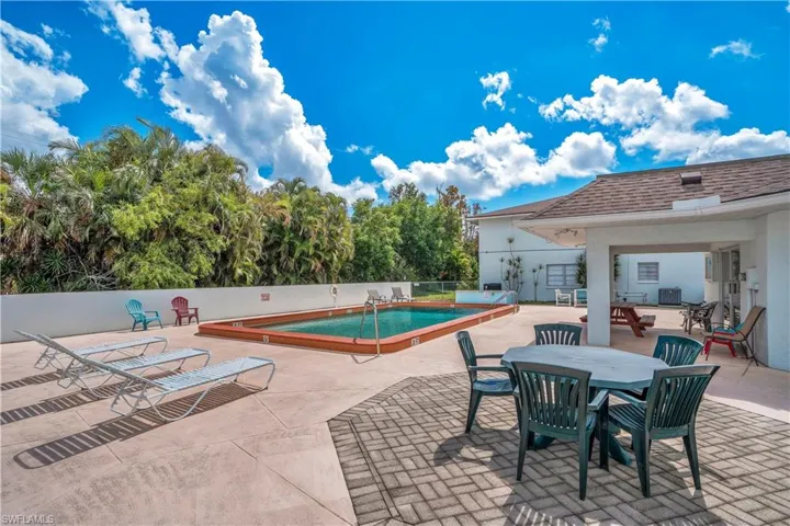 Community pool with a patio