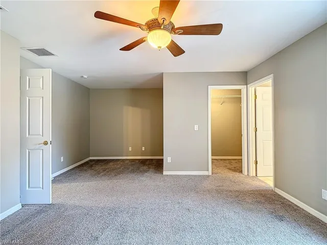 Spare room featuring carpet flooring and ceiling fan