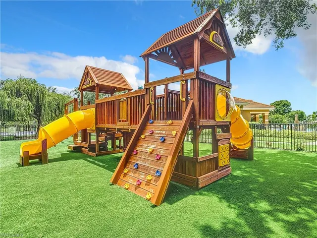 View of jungle gym with a lawn