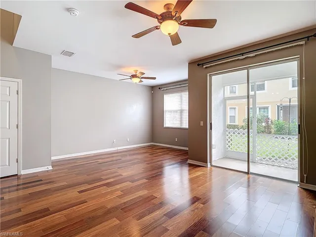 Unfurnished room with plenty of natural light, hardwood / wood-style flooring, and ceiling fan
