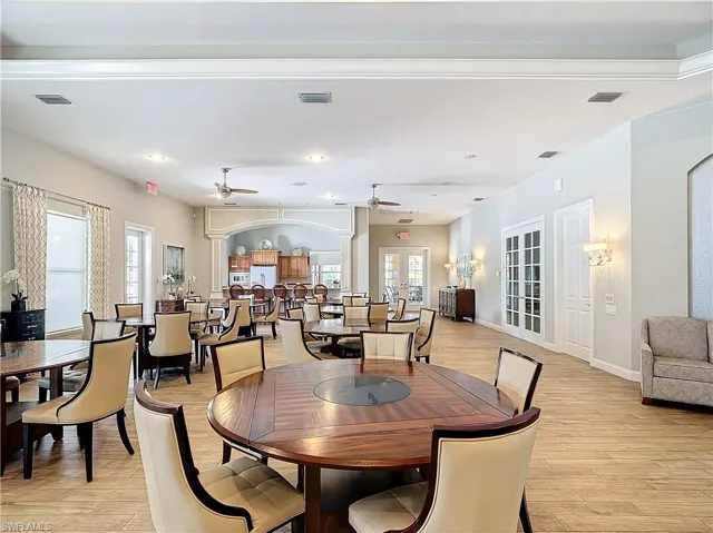 Dining space with a wealth of natural light, ceiling fan, french doors, and light hardwood / wood-style flooring