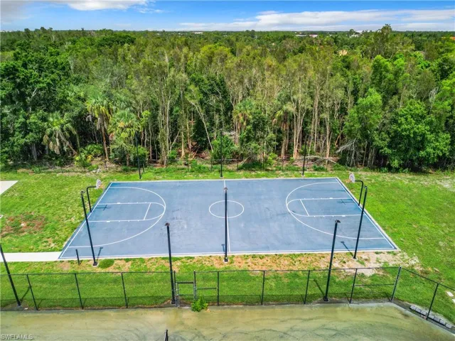 View of sport court featuring a yard