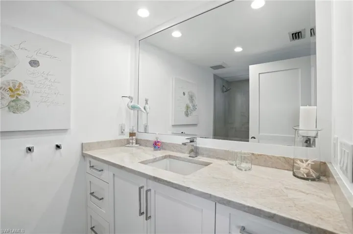 Full bathroom with recessed lighting and vanity