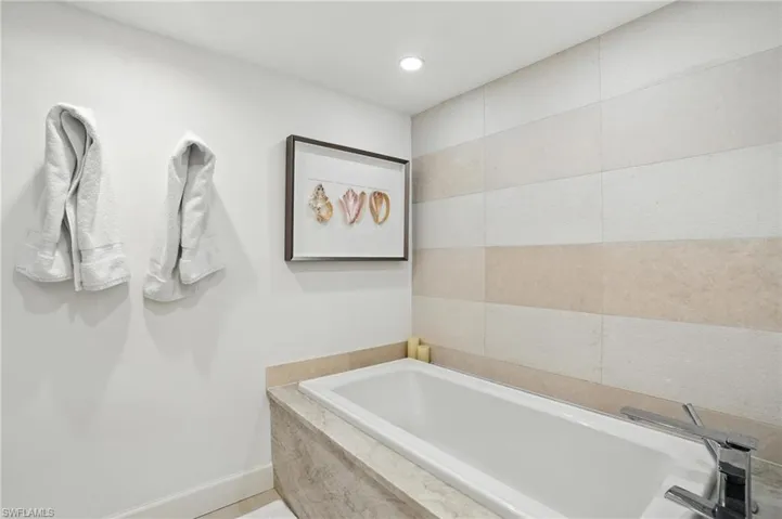 Bathroom featuring a bath and recessed lighting