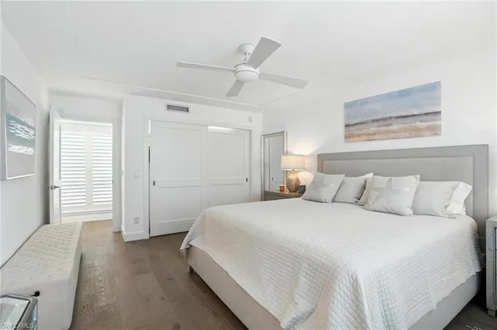 Bedroom featuring wood finished floors, a closet, and a ceiling fan