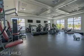 Workout area with coffered ceiling and beam ceiling
