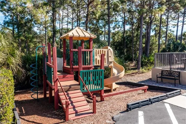 View of community jungle gym next to pool.