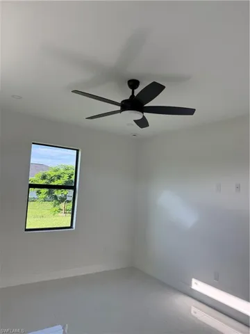 Spare room featuring ceiling fan and light tile patterned flooring
