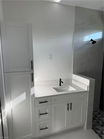 Full bath with walk in shower and vanity