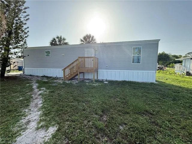 Rear view of property with a lawn