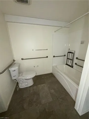 Bathroom with shower / bathtub combination and toilet