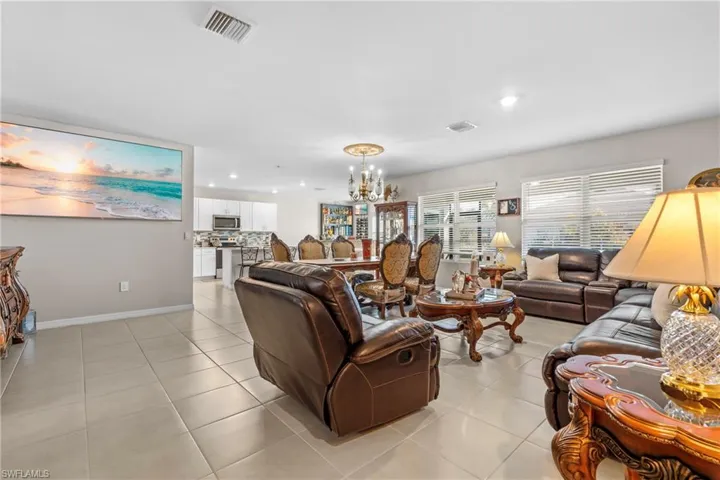 Living room featuring hanging lights and light tile patterned flooring