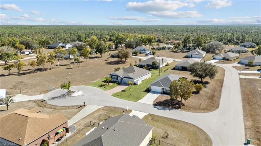 Aerial perspective of suburban area with a heavily wooded area