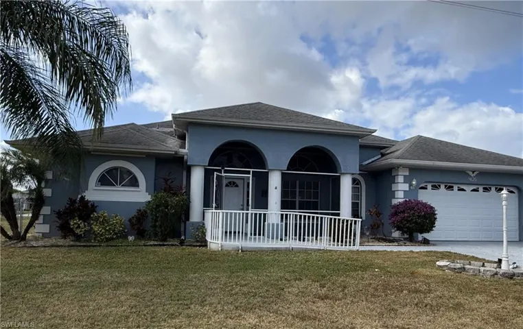 View of front of property featuring a front yard and a garage